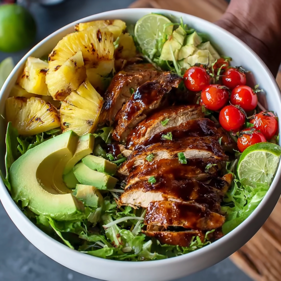 A bowl of food with a pineapple, tomato, and lime.