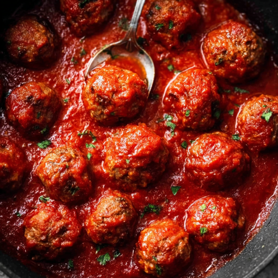 A bowl of meatballs in a red sauce.