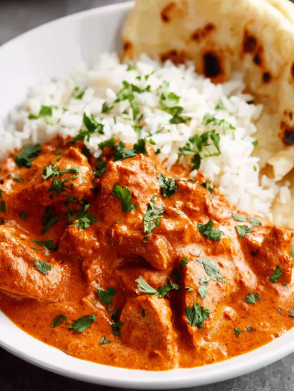 A bowl of food with rice and meat.