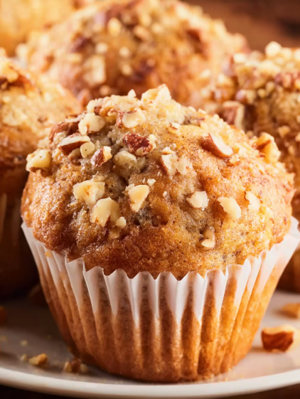 A cupcake with nuts on top.
