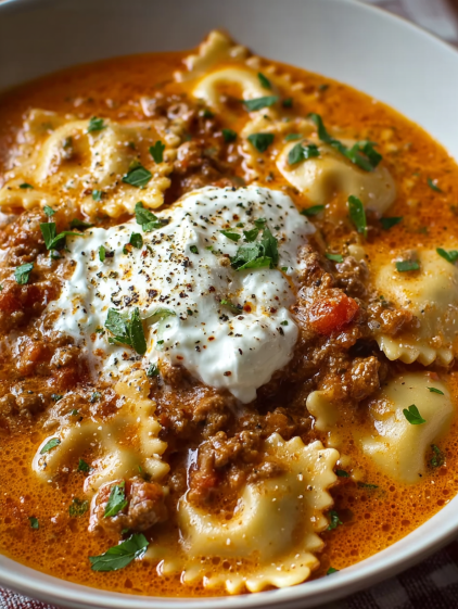 A bowl of pasta with meat sauce and cheese.