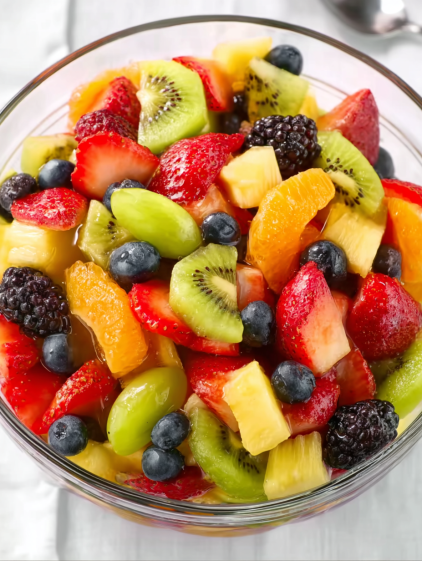 A bowl of fruit with blueberries, strawberries, kiwi, and oranges.