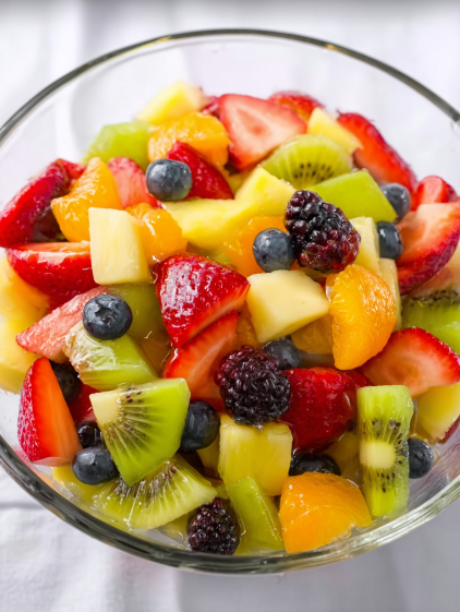 A bowl of fruit with strawberries, kiwi, blueberries, and oranges.