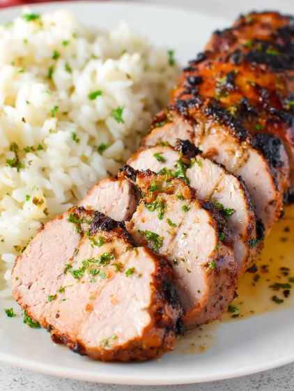 A piece of meat with rice and herbs.
