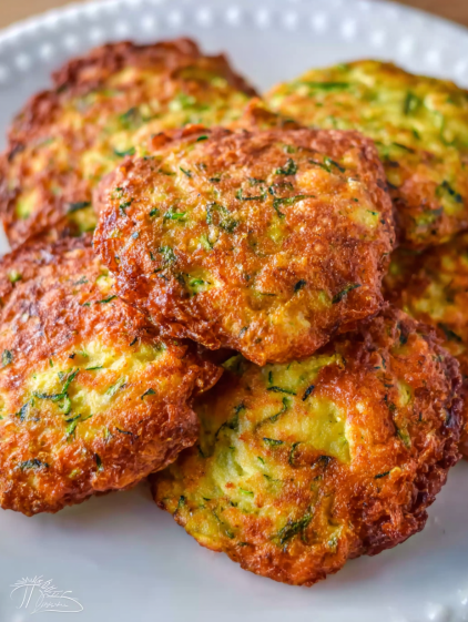 A plate of food with a green herb on top.