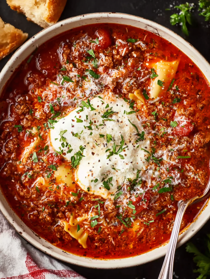 A bowl of pasta with meat sauce and cheese.