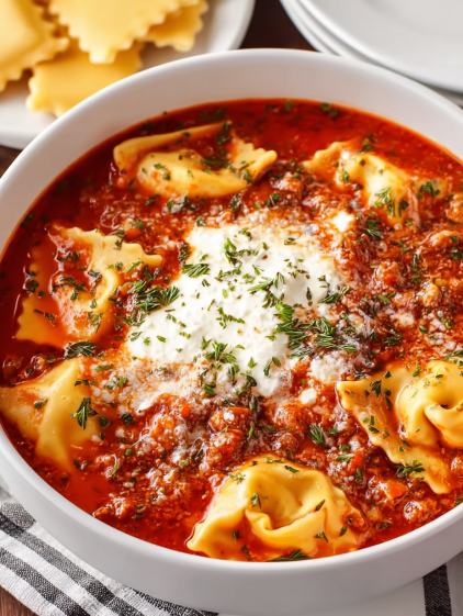 A bowl of pasta with white cheese on top.