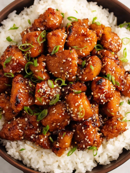 A plate of food with rice and chicken.
