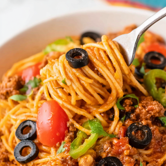A spaghetti dish with meat and tomatoes.