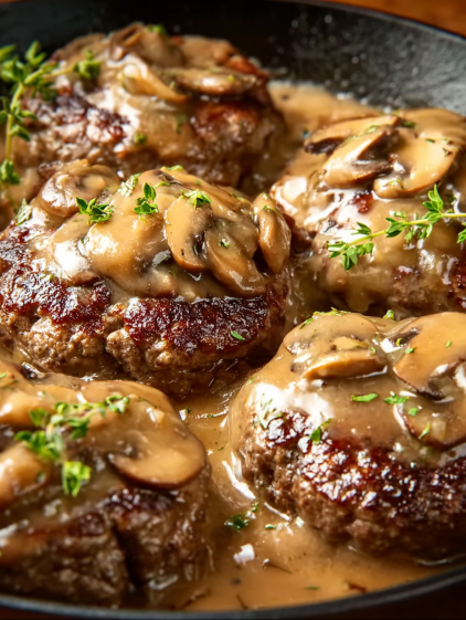 A close up of a meatball covered in gravy.