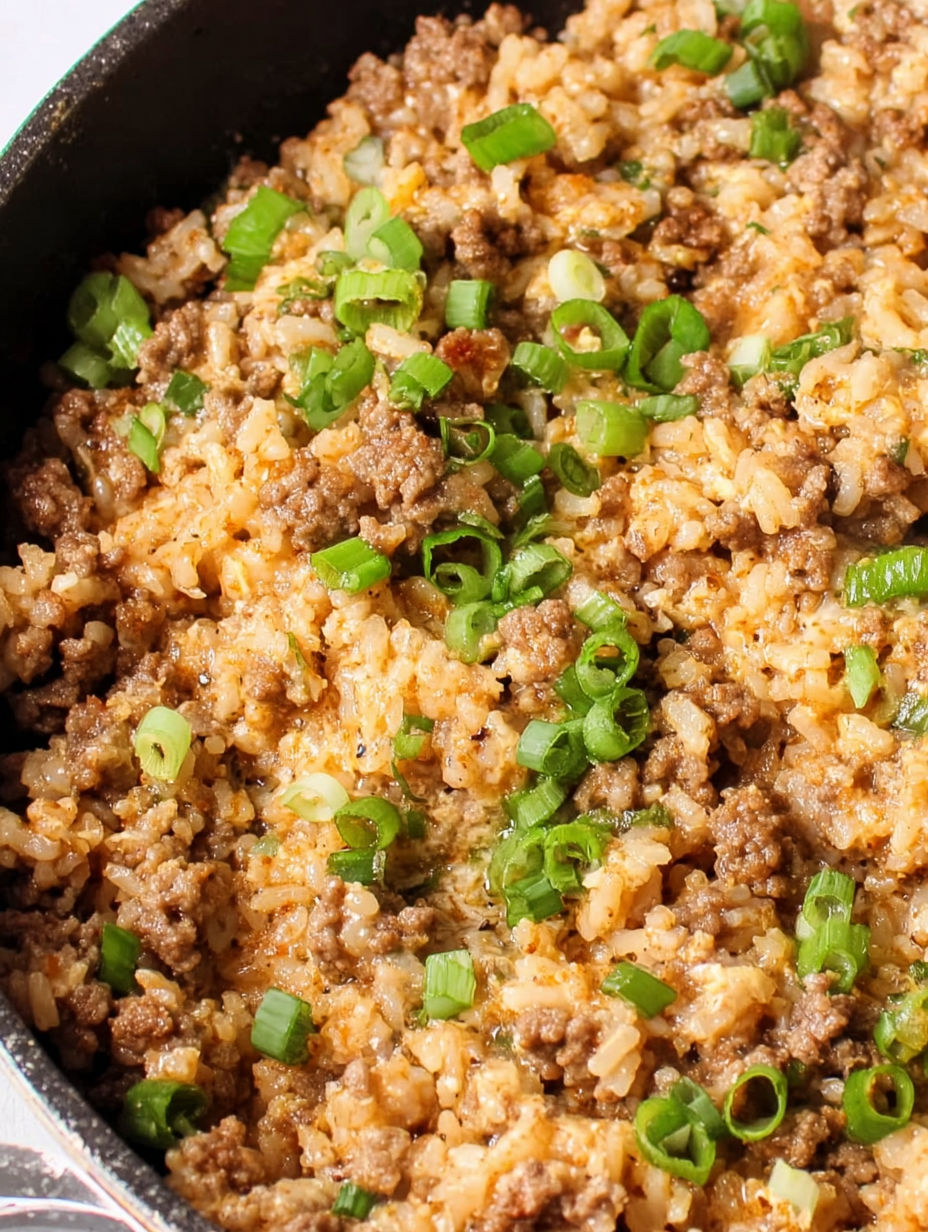 A bowl of rice with green onions.