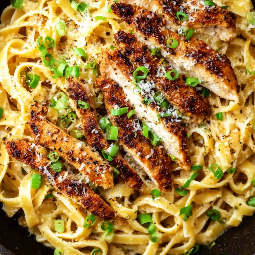 A dish of chicken and pasta with a lemon pepper seasoning.