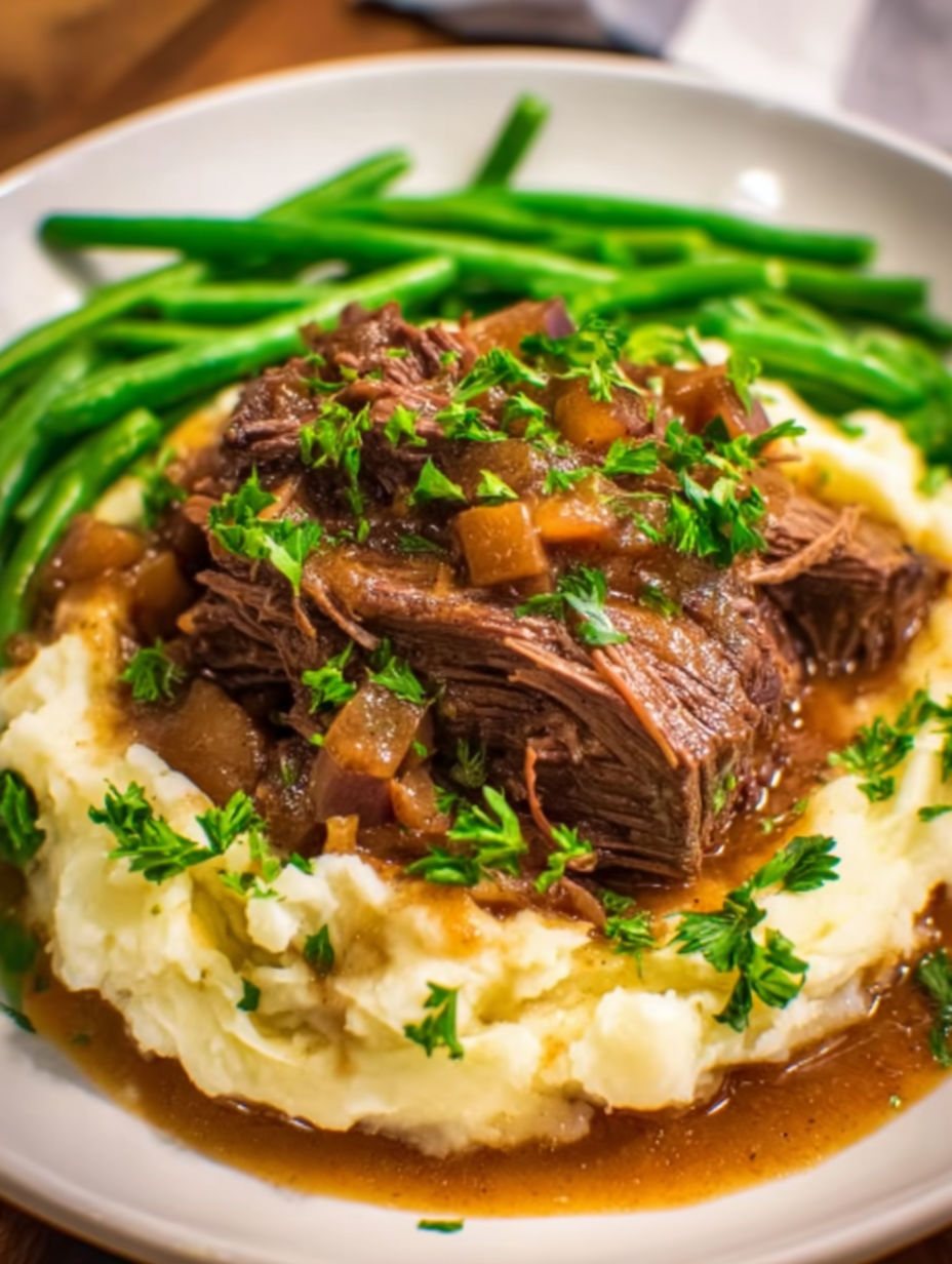 A close up of a pot roast with green beans.