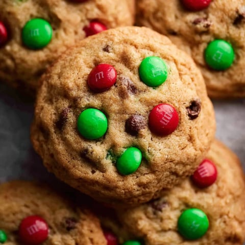 A close up of a cookie with green and red M&M's.