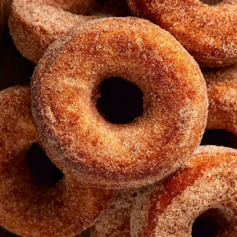 A pile of sugar donuts.