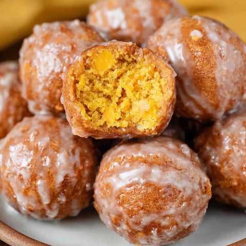 Pumpkin donut holes on a plate.