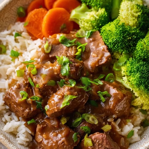 A bowl of beef tips and gravy.