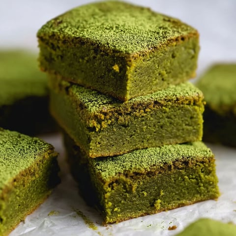 A stack of green squares of cake.