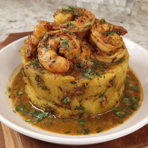 A plate of food with shrimp and garlic butter.