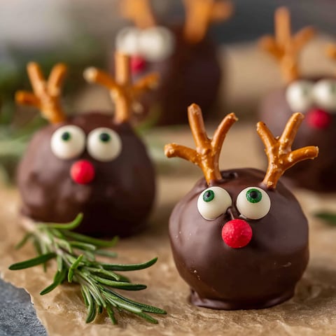 A plate of chocolate covered peanut butter balls with rice krispies.