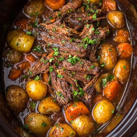 A pot of beef and potatoes in a crock pot.